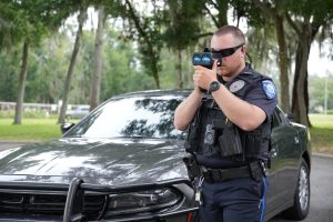 Male officer using traffic laser