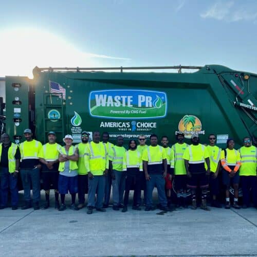 group of Sanford Employees standing in front of a waste pro truck